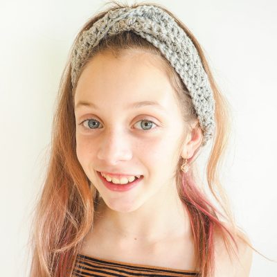 This free crochet pattern will keep your ears warm and your hair looking good. This crochet headband is such a fun and beautiful project to make. #CrochetHeadband #CrochetPattern #CrochetAddict