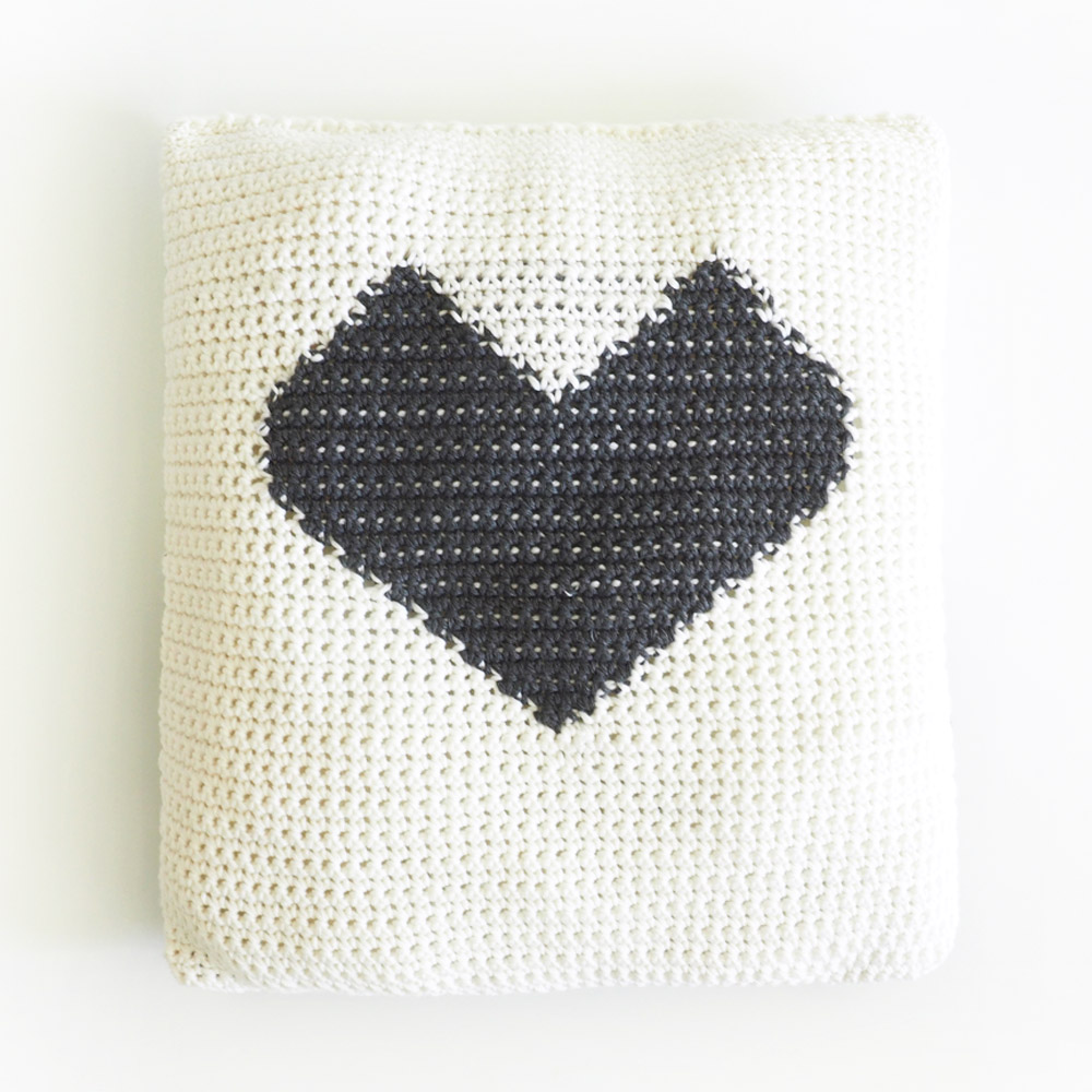 This crochet throw pillow is perfect for brightening up a space in a subtle way. You’ll get to learn the crochet graphgan technique on a smaller scale. #CrochetPillow #CrochetPillowPatterns #CrochetPatterns