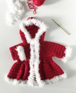 Christmas Baby Sweater - Here are 13 free crochet sweater patterns for the holiday season, including adorable outfits for baby, and out-of-this-world ugly Christmas sweaters! #freecrochetsweaterpatterns #crochetpatterns #crochetsweaters