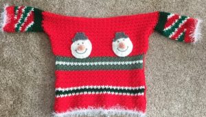 Ugly Christmas Sweater - Here are 13 free crochet sweater patterns for the holiday season, including adorable outfits for baby, and out-of-this-world ugly Christmas sweaters! #freecrochetsweaterpatterns #crochetpatterns #crochetsweaters