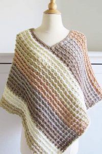 Sunset Poncho - These free crochet poncho patterns may be used this winter, but many of the designs here can also work up to spring and even on a cool summer day! #freecrochetponchopatterns #crochetponcho #crochetpatterns