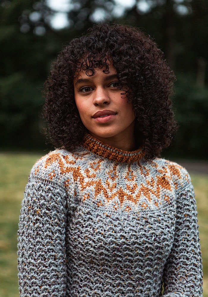 a woman wearing the colorwork yoke crochet sweater