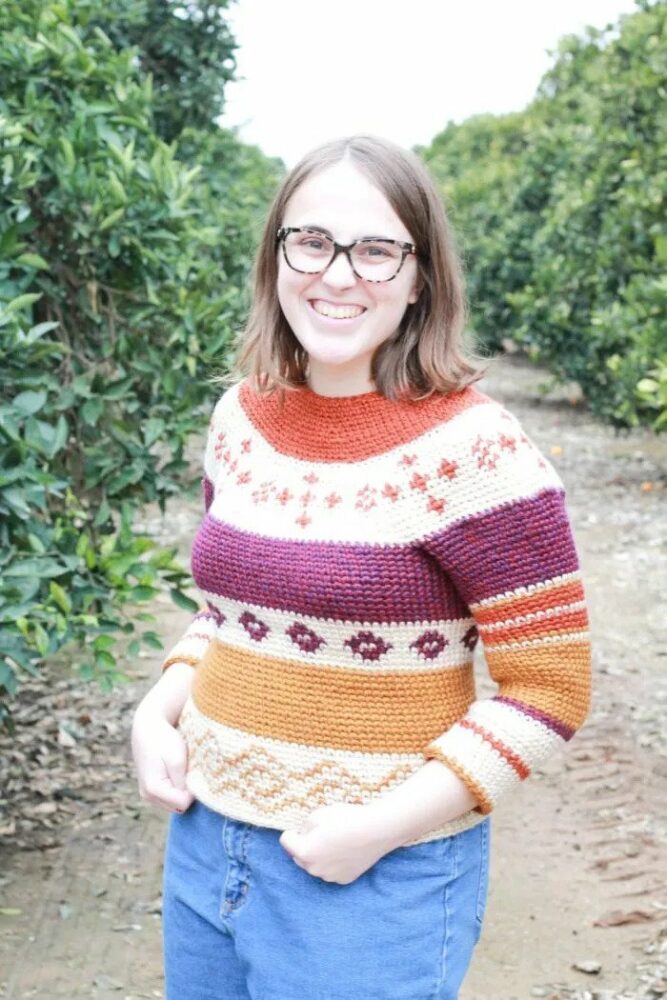 a woman wearing a crochet sweater  inspired by Fair Isle knitting colorwork