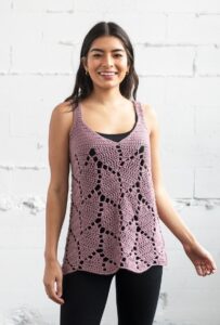 a woman wearing a lacy crochet tank