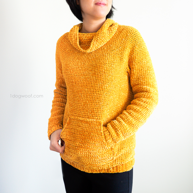 a woman wearing a yellow crochet hoodie