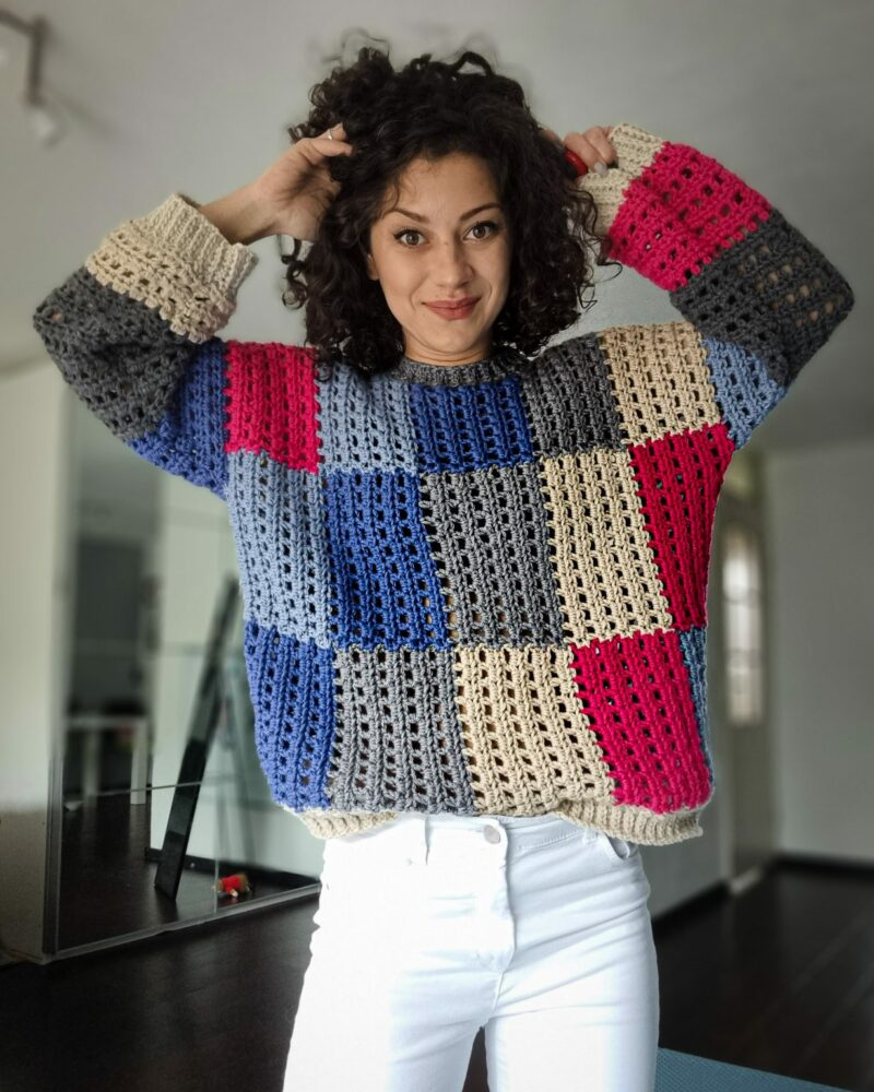 a woman wearing a classic drop shoulder crochet sweater 