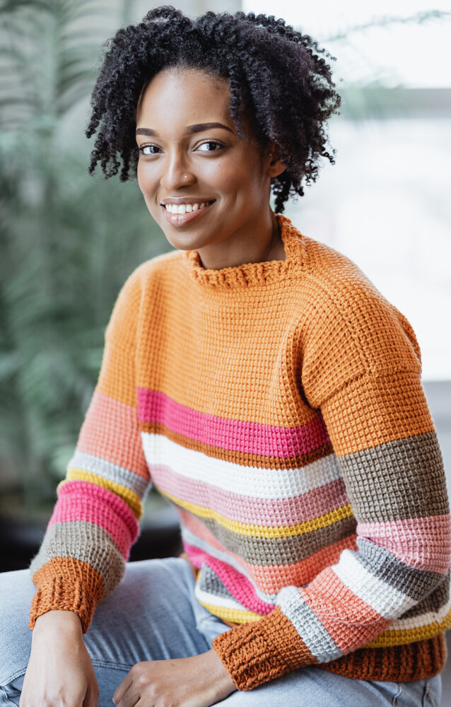 a woman wearing the Sedona Crochet Sweater