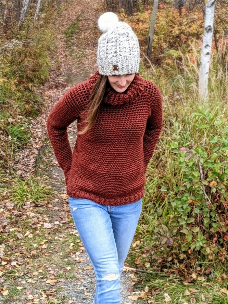 a woman wearing a bulky crochet sweater