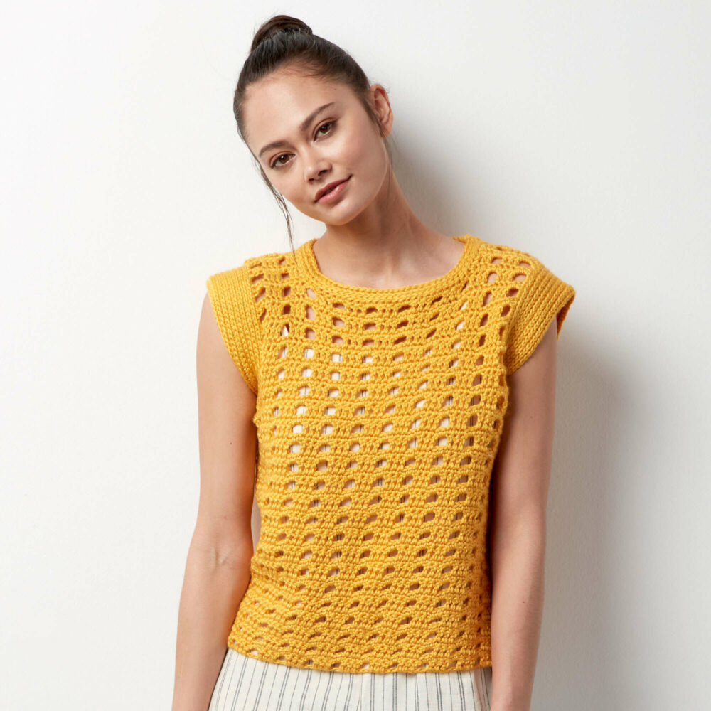a wooman wearing the Caron Hello, Yellow! Crochet Top