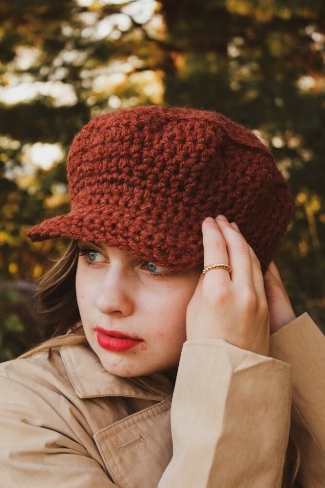 A woman wearing a Red Newsboy Crochet Hat 
