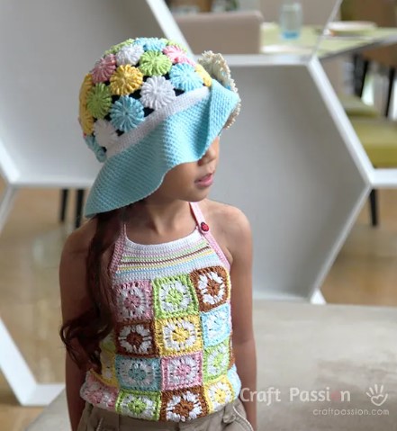 A girl wearing the Yoyo Puff Wide Brim Crochet Hat