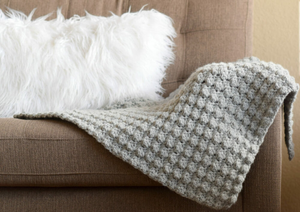go-to simple easy crochet blanket on sofa with fluffy cushion