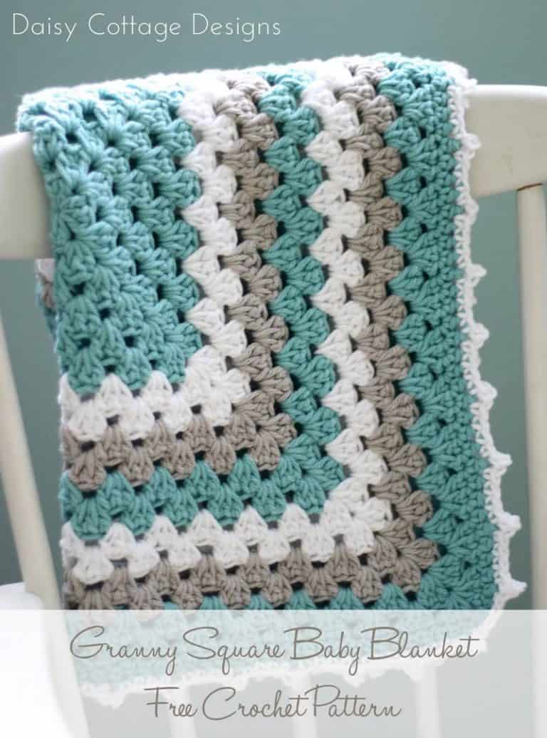 folded granny square crochet blanket on a white wooden chair